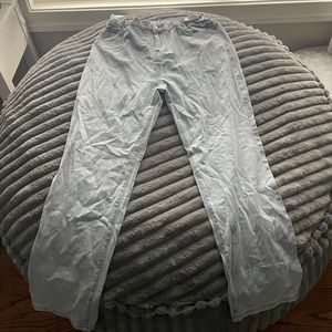 Size Large light wash low rise adjustable waist jeans.